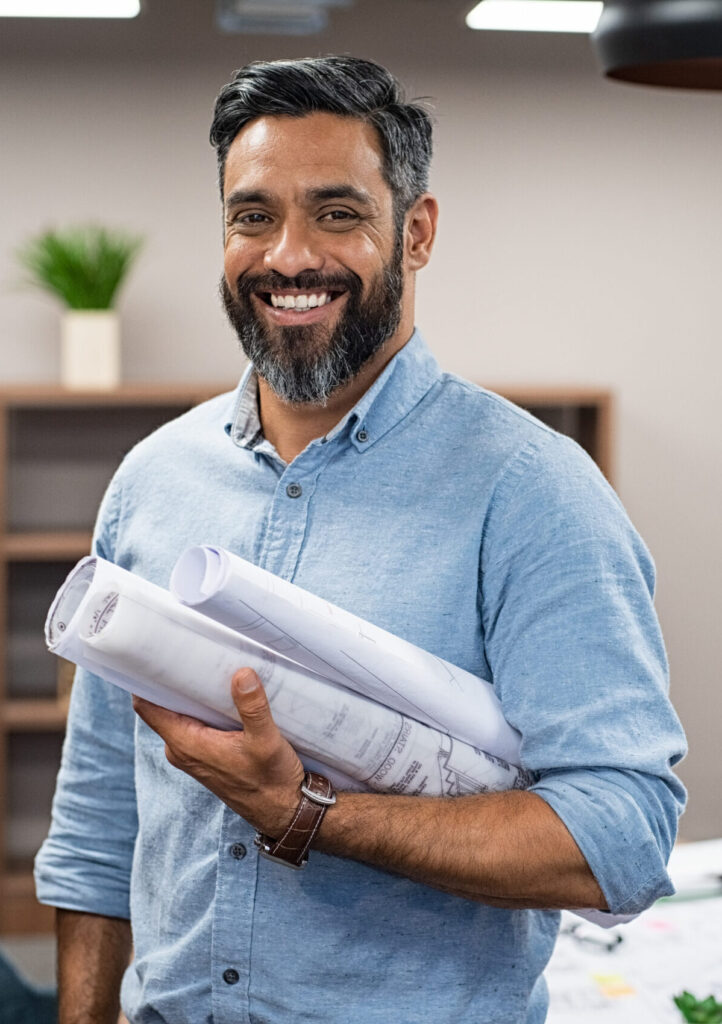 Smiling architect with rolled blueprints under his arm